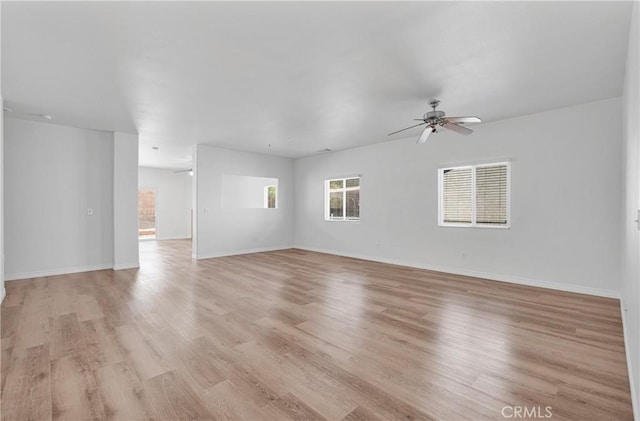 empty room featuring ceiling fan and light hardwood / wood-style flooring