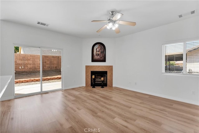 unfurnished living room with ceiling fan and light hardwood / wood-style flooring