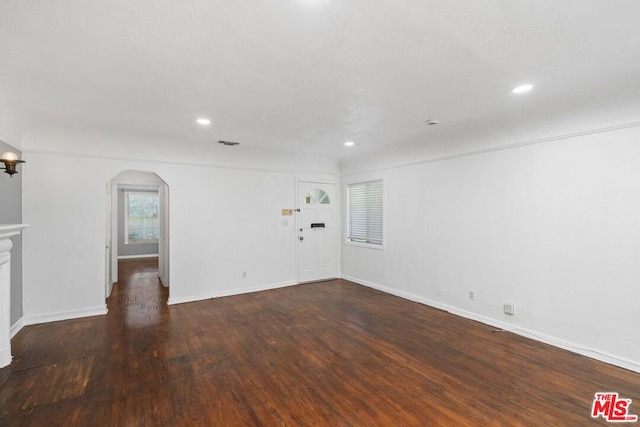 empty room with dark wood-type flooring