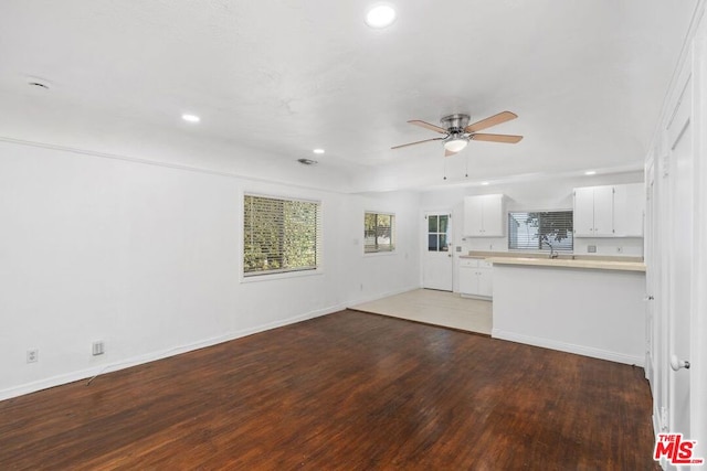 unfurnished living room with hardwood / wood-style flooring and ceiling fan