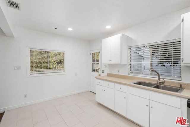 kitchen featuring white cabinets, white dishwasher, and sink