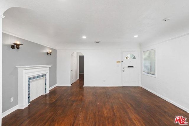 unfurnished living room featuring dark hardwood / wood-style floors