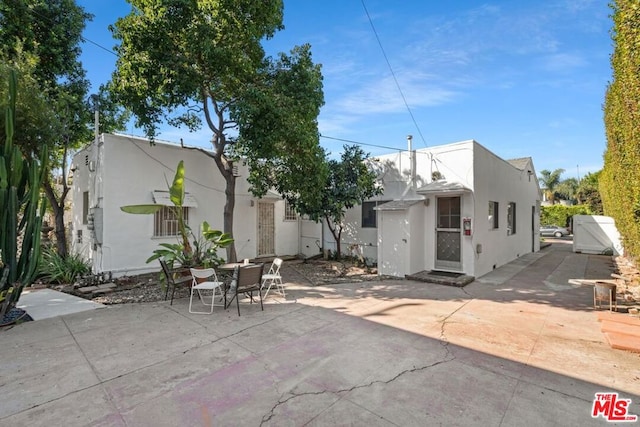 back of house with a patio