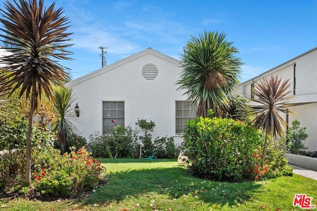 view of side of home featuring a lawn