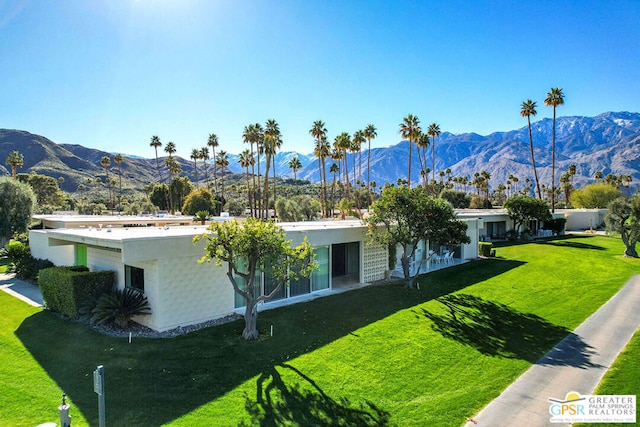 exterior space with a lawn and a mountain view