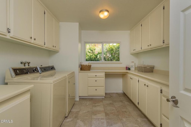 washroom featuring cabinets and washing machine and dryer