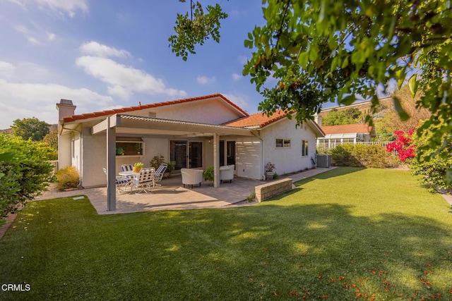 back of property featuring a yard, a patio, and central air condition unit