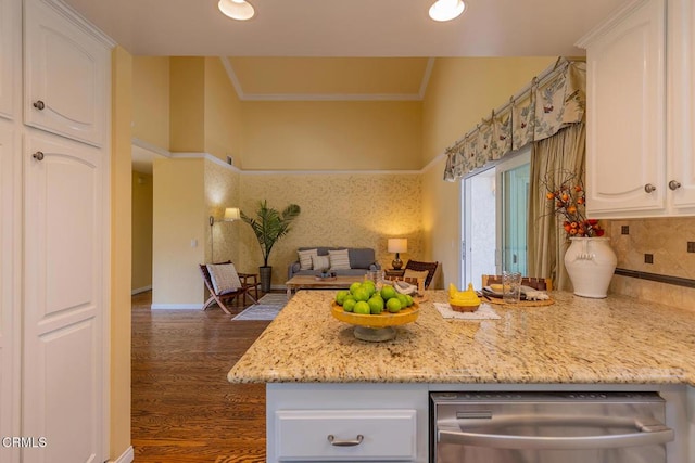 kitchen with decorative backsplash, light stone countertops, stainless steel dishwasher, white cabinets, and dark hardwood / wood-style floors