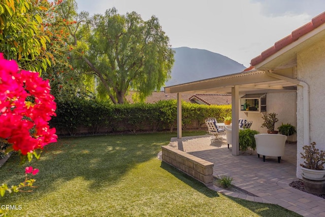 view of yard with a mountain view and a patio