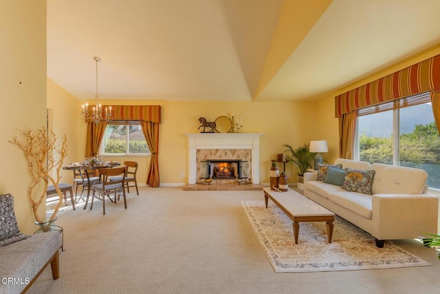 living room featuring a high end fireplace, carpet, and a notable chandelier