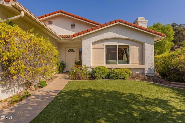 doorway to property featuring a yard