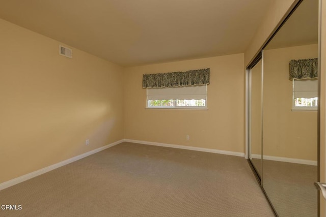 unfurnished bedroom featuring a closet and carpet