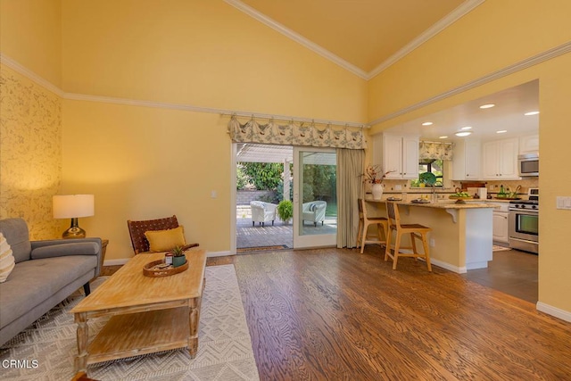 living room featuring high vaulted ceiling, ornamental molding, and hardwood / wood-style flooring