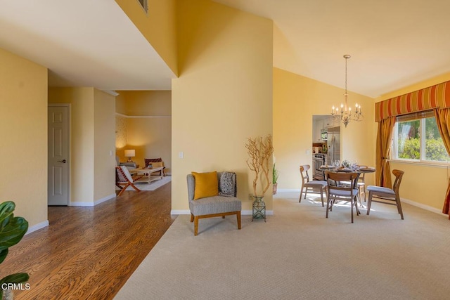 dining area with a chandelier, lofted ceiling, and dark wood-type flooring