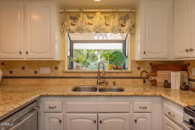 kitchen with white cabinetry, sink, dishwasher, light stone countertops, and backsplash