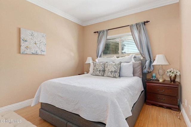 bedroom featuring light wood-type flooring and ornamental molding