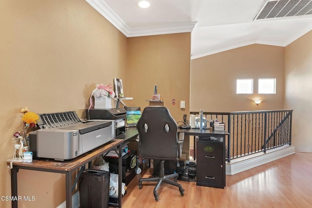 home office with hardwood / wood-style flooring and crown molding