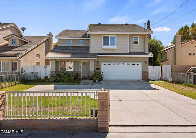 front facade featuring a garage and a front lawn