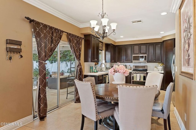 dining space with light tile patterned floors, an inviting chandelier, sink, and ornamental molding