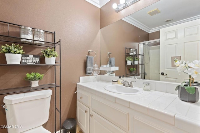 bathroom with toilet, vanity, a skylight, crown molding, and walk in shower