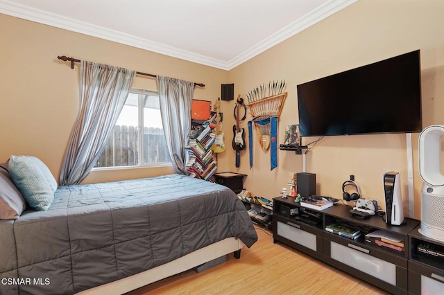 bedroom with light wood-type flooring and crown molding