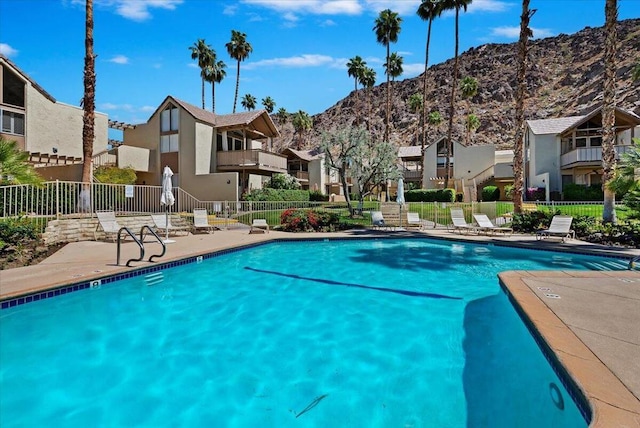 view of swimming pool with a mountain view