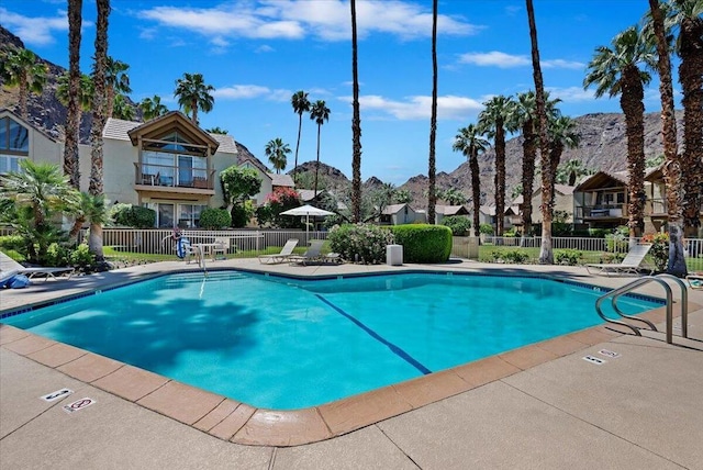 view of swimming pool with a mountain view and a patio