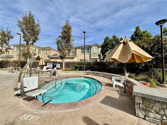 view of swimming pool with a patio area and a hot tub