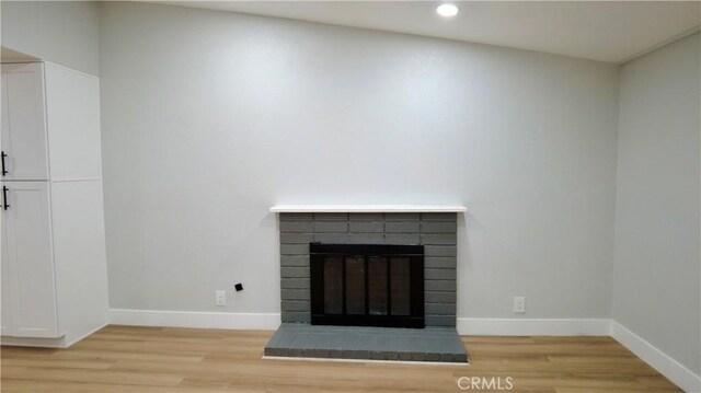 interior details featuring hardwood / wood-style flooring and a fireplace