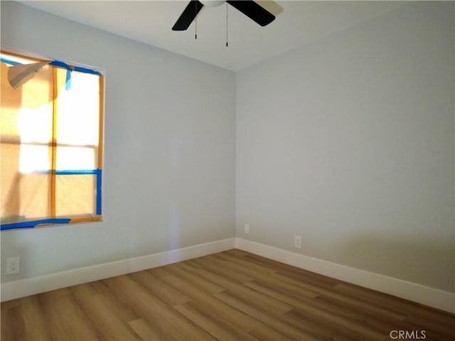 unfurnished room with hardwood / wood-style flooring and ceiling fan