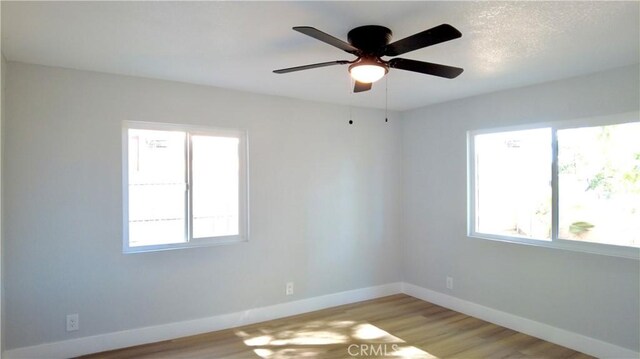 spare room featuring light hardwood / wood-style flooring and ceiling fan