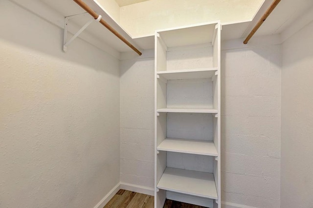 spacious closet featuring hardwood / wood-style floors