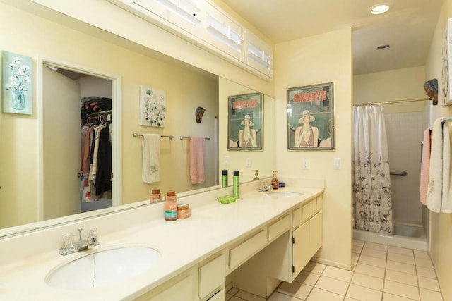 bathroom with a shower with curtain, vanity, and tile patterned flooring