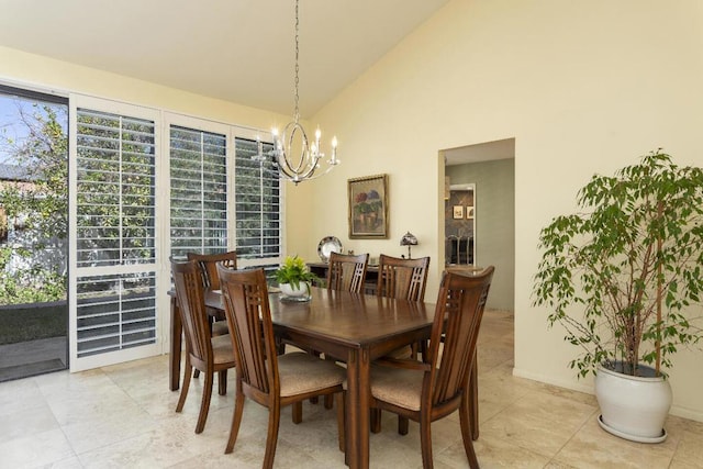 dining area featuring light tile patterned floors, a notable chandelier, and high vaulted ceiling