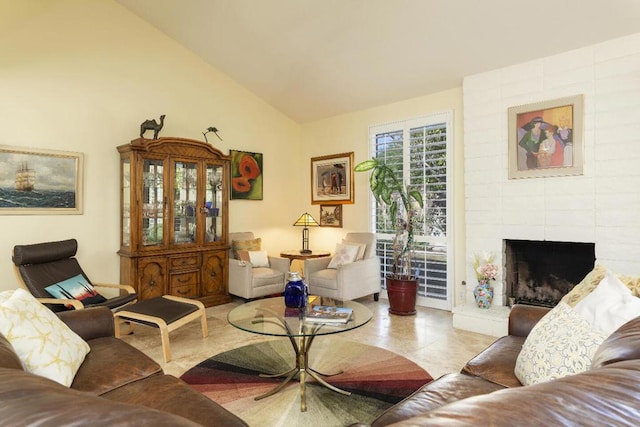 living room with vaulted ceiling and a brick fireplace