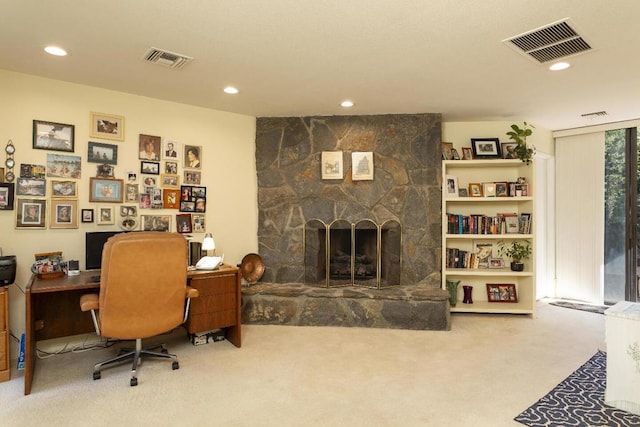 home office featuring carpet flooring and a fireplace