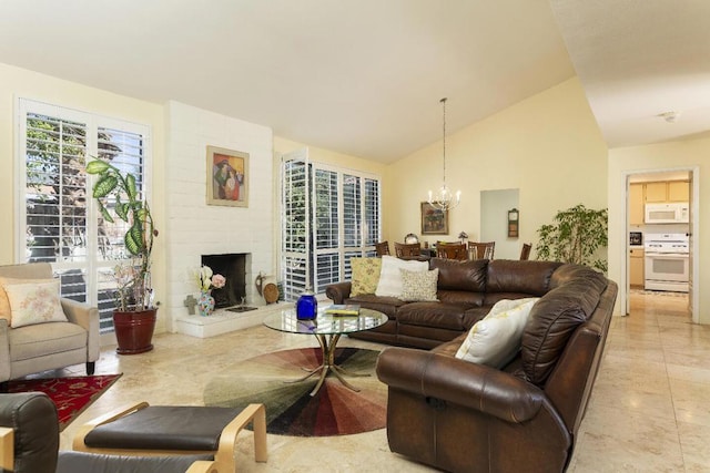 living room featuring lofted ceiling, a large fireplace, and a chandelier