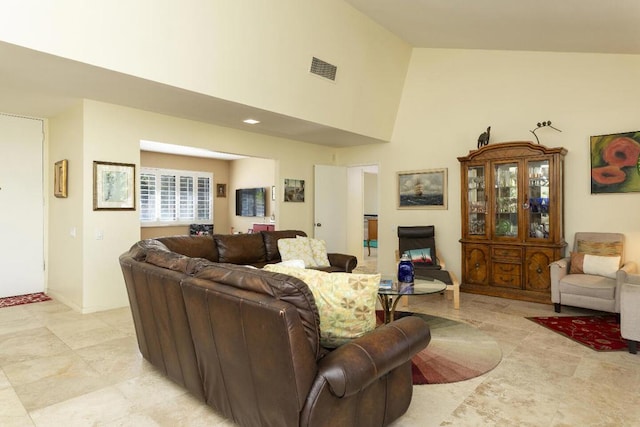 living room with high vaulted ceiling