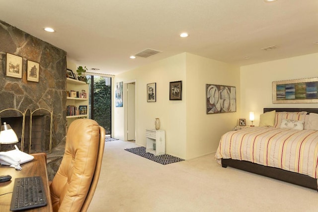 carpeted bedroom featuring a stone fireplace and access to exterior