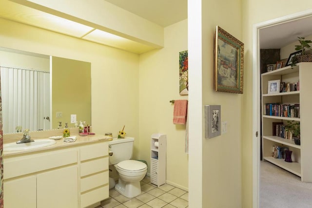 bathroom featuring tile patterned flooring, vanity, and toilet