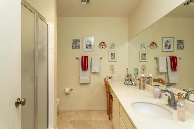 bathroom with vanity, toilet, and a shower with shower door