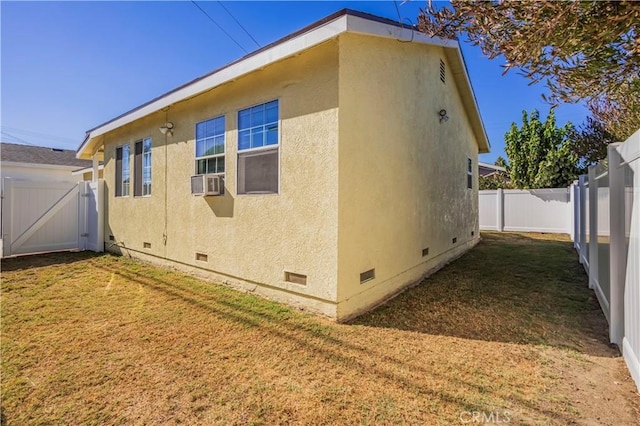 view of side of home with a yard