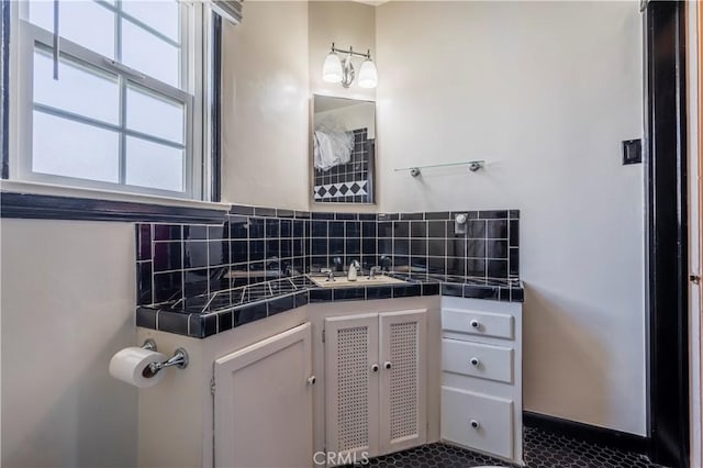 bathroom featuring decorative backsplash and vanity