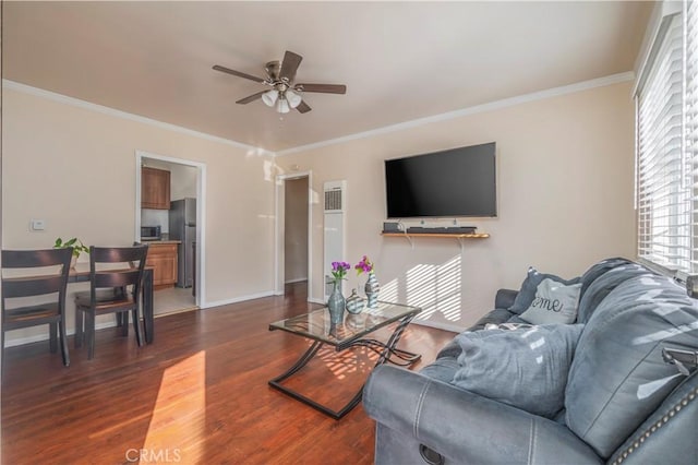 living room featuring ceiling fan, dark wood-type flooring, and ornamental molding