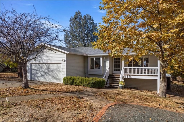 view of front of house featuring a porch and a garage