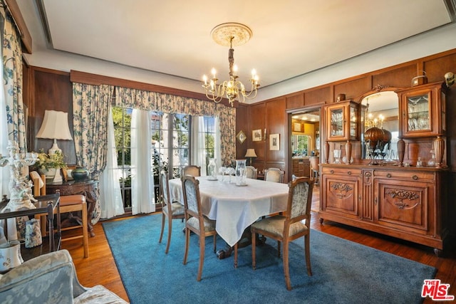 dining space featuring a chandelier and dark hardwood / wood-style floors