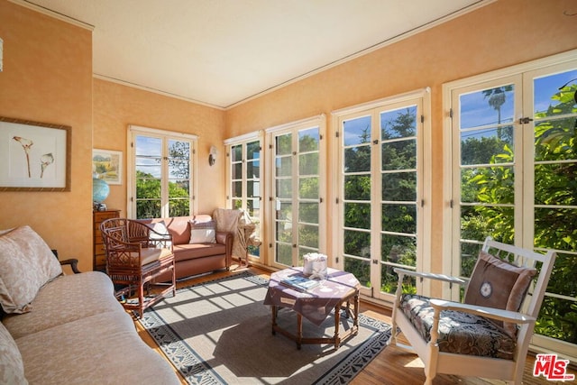 sunroom / solarium featuring french doors