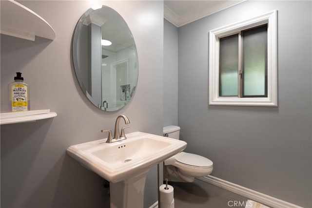 bathroom with crown molding, sink, and toilet