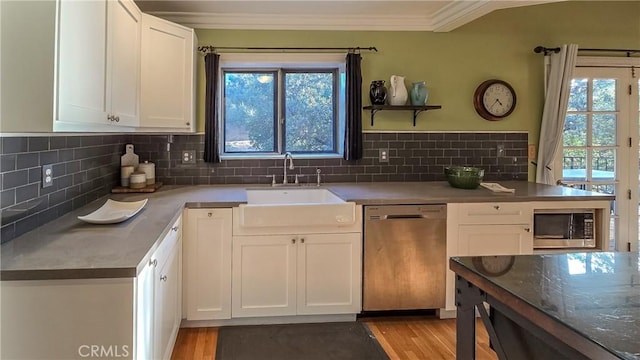 kitchen featuring a healthy amount of sunlight, sink, white cabinets, and stainless steel appliances