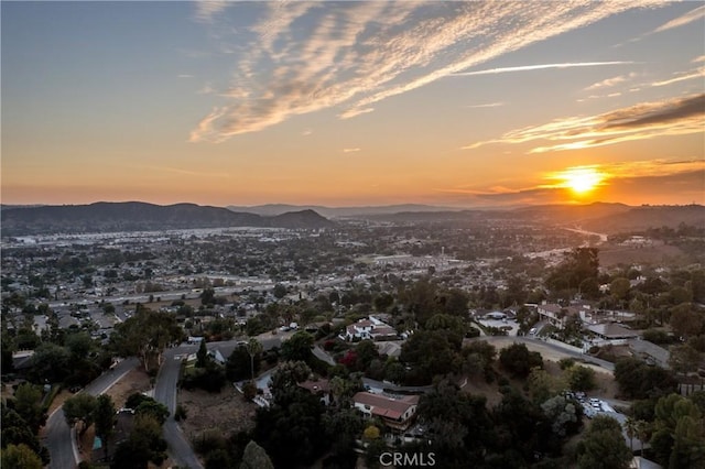 aerial view at dusk featuring a mountain view